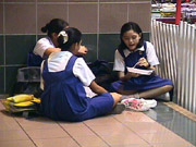 3 girls lunch on floor in mall